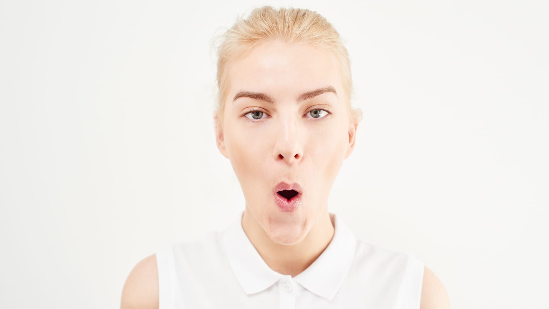 Facial gymnastics: cheekbone lifting exercises.